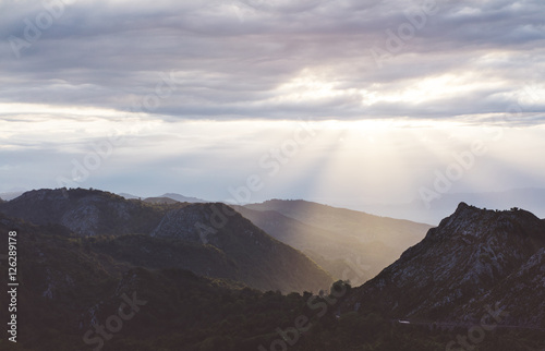Sunset in the mountain natural landscape park. Green valley on background dramatic sky and clouds. Panorama horizon view of scenery foggy hills Northern Spain alps. Travel mockup concept in evening