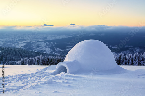 Marvelous huge white snowy hut. © Vitalii_Mamchuk
