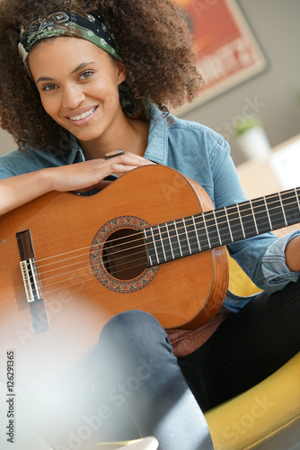 Картината върху платно Cheerful girl playing the guitar