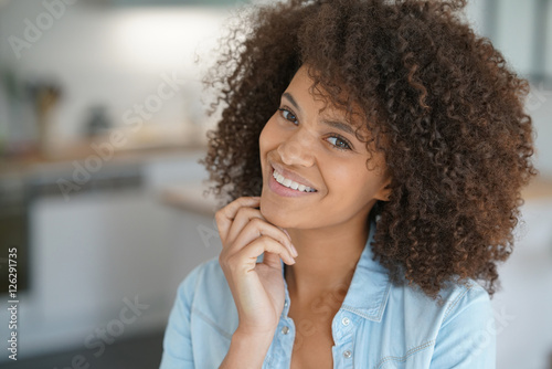 Attractive smiling mixed-race girl at home