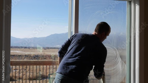 Wallpaper Mural A man cleans house windows during the day Torontodigital.ca