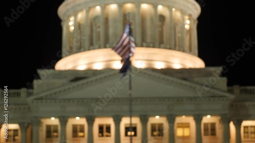 Flag flies at the Utah State Capitol at night rack shot
