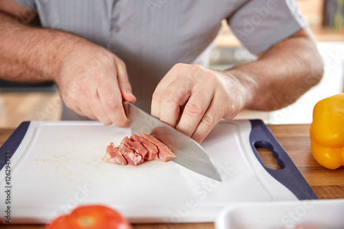 Cutting steak meat closeup of man