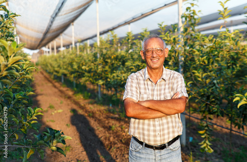 Portrait of senior man in his orchard.
