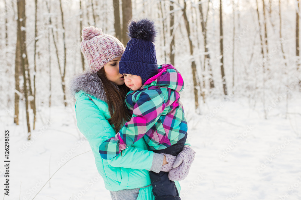 Mother and child enjoying beautiful winter day outdoors