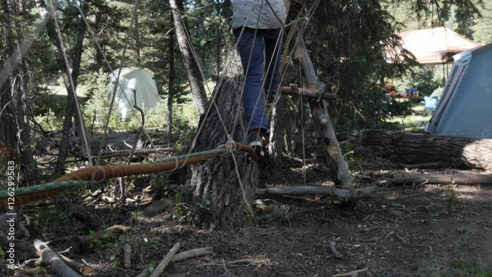 Gimbal shot of scout on a rope monkey bridge at scout camp Gimbal shot of scout on a rope monkey bridge at scout camp