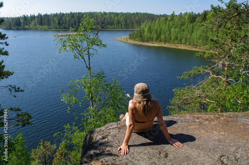 woman enjoys views of the lake. A relax on the lakeshore with forest arround. Supervision over the horizon. © evolutionnow