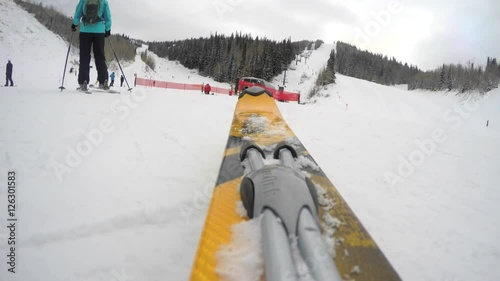 A low shot of skis going down a mountain on cold day