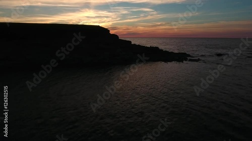 Aerial shot of beautiful coastline at Cape Breton Island with sunset photo