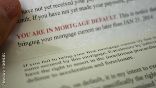 Man reading final notice foreclosure letter from bank photo