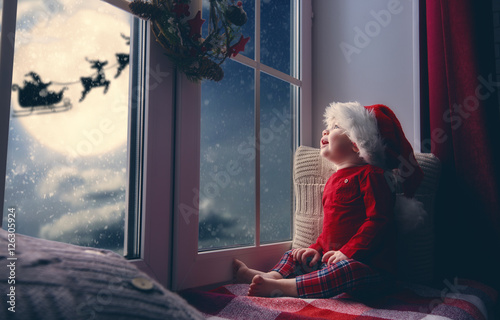 baby girl sitting by the window photo