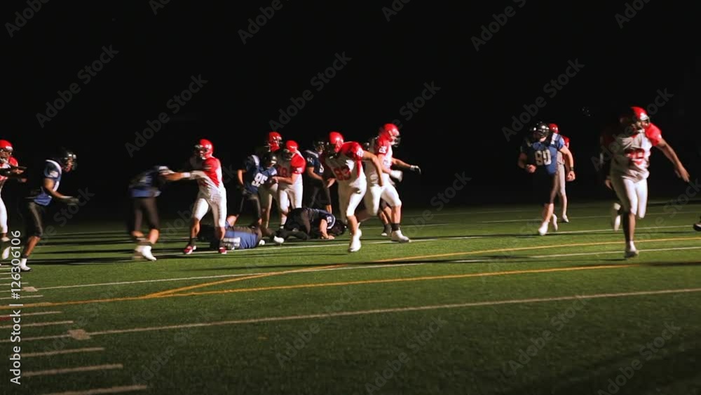 a football player running down the field trying to score a touchdown a football player running down the field trying to score a touchdown