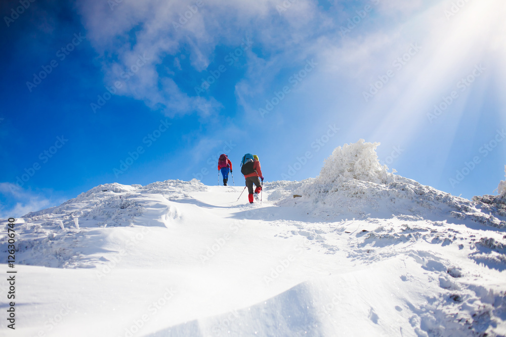 Climbers are on snow slope.