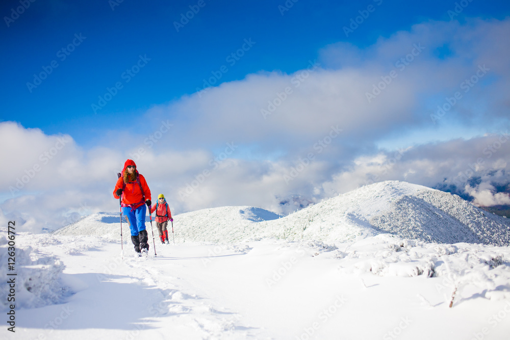 Climbers are on snow slope.