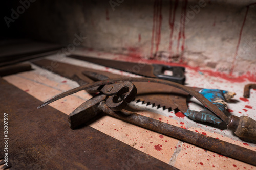 Close up of saws, sickles, hammer and other devices on the blood