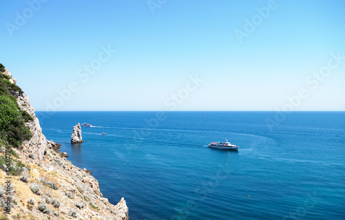 many pleasure boats floating in the sea along the coast