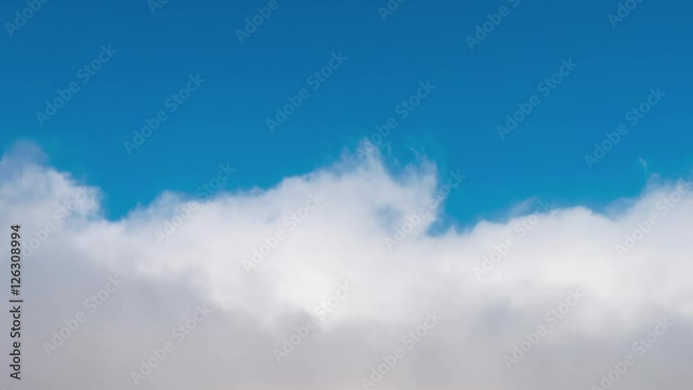 First person view (POV) flying through white fluffy clouds against a blue sky. Timelapse. First person view (POV) flying through white fluffy clouds against a blue sky. Timelapse.