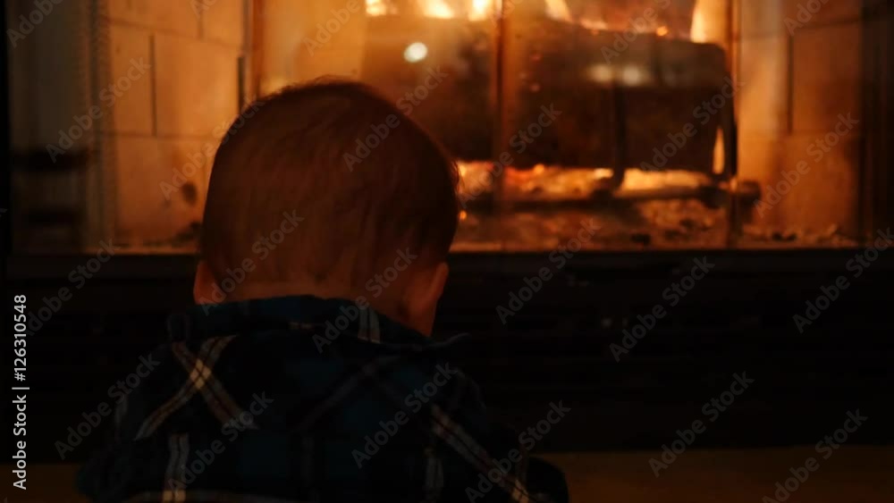 Baby boy sitting by their home fireplace Baby boy sitting by their home fireplace