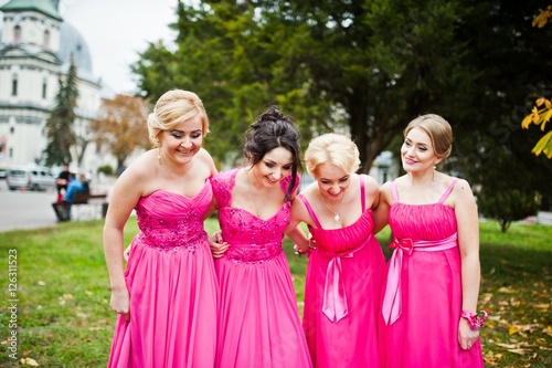 Stylish bridesmaids in pink dresses background yellow trees