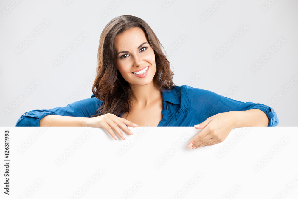Beautiful young woman showing blank signboard Beautiful young woman showing blank signboard