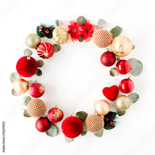 christmas wreath frame made of colored bright christmas balls on white background. flat lay, top view