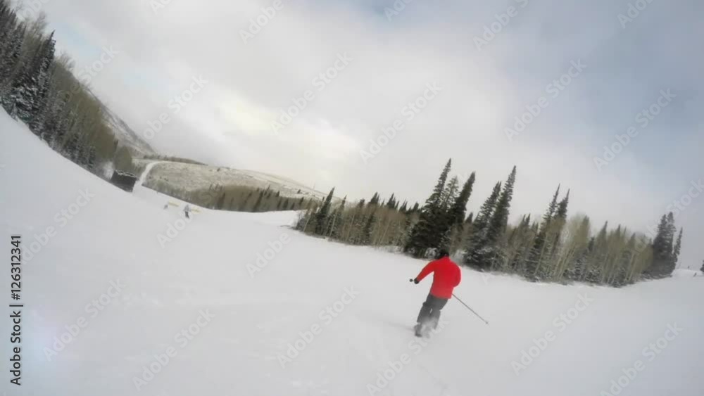 Slow motion shot of a man skiing fast down the mountain resort hill Slow motion shot of a man skiing fast down the mountain resort hill