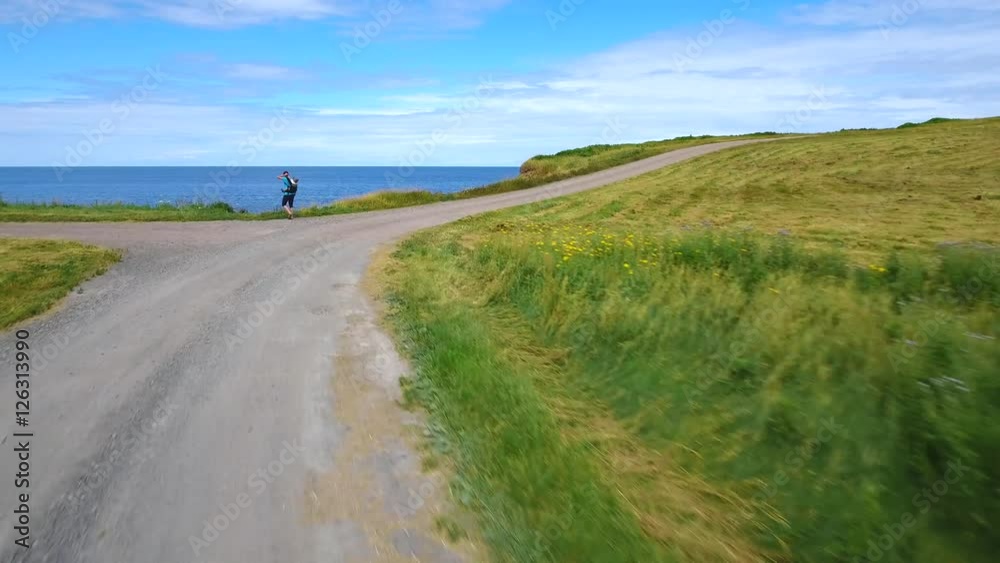 Aerial shot of mother and baby walking toward the ocean coast Aerial shot of mother and baby walking toward the ocean coast