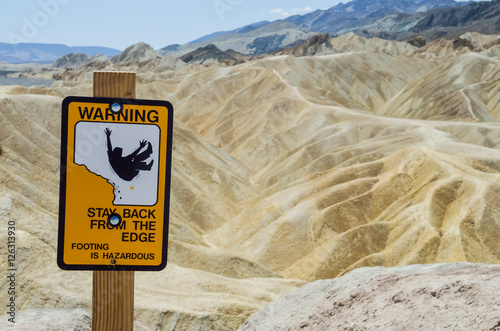 Warning sign at Zabriskie Point furnace creek formations in Death Valley National Park, California, USA photo