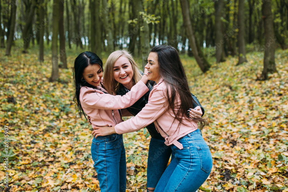 Happy three teen friends. Stylish girls in the autumn park posing. Happy three teen friends. Stylish girls in the autumn park posing.