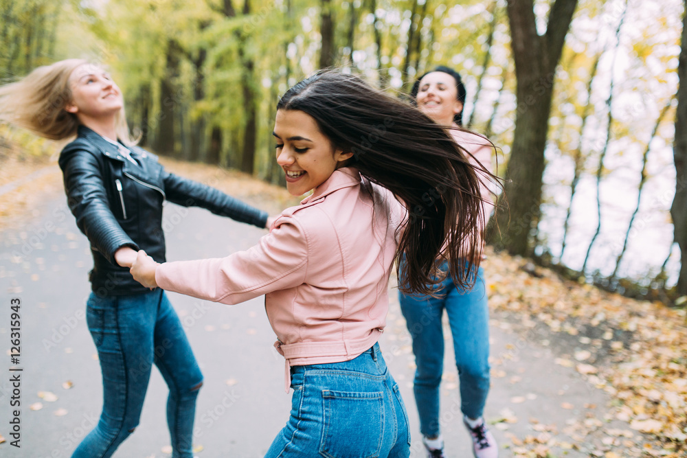 © anatoliycherkas - Happy three teen friends. Stylish girls in the autumn park posing.