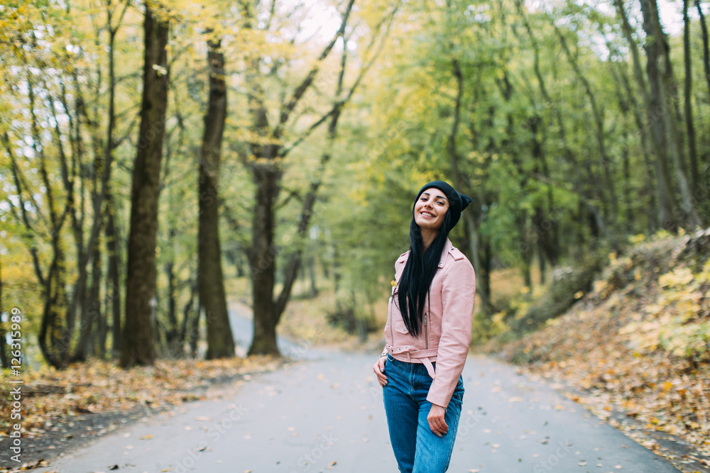Beautiful, stylish and fashionable girl posing in autumn park Beautiful, stylish and fashionable girl posing in autumn park