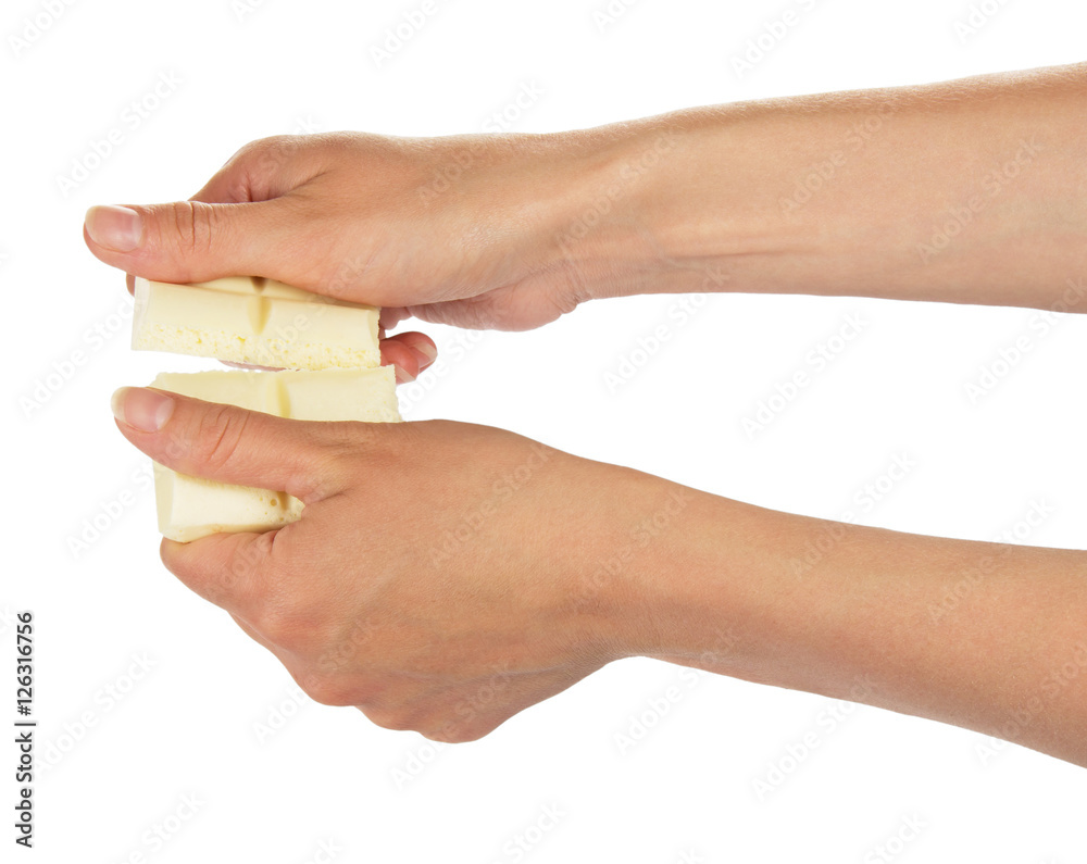 Female hands break bar of white chocolate isolated. Female hands break bar of white chocolate isolated.