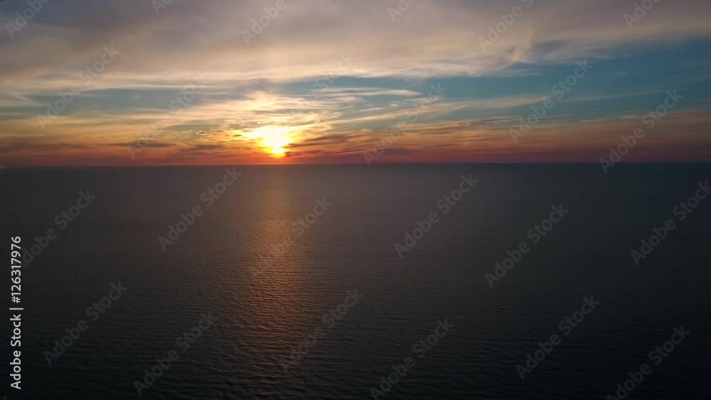 Aerial shot of a beautiful ocean sunset above calm sea Aerial shot of a beautiful ocean sunset above calm sea