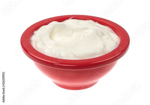 Bowl of cocoa butter cream skin lotion isolated on a white background.