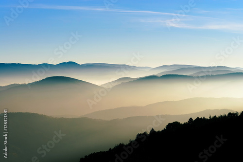Aerial view of colorful autumnal mountains, foggy sunset