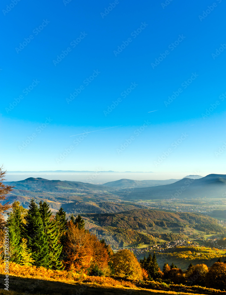 Obraz premium Aerial view of colorful autumnal mountains, foggy sunset