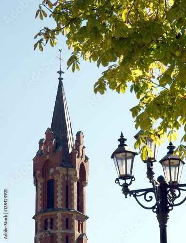tower of church and street lamp in Kolaczyce town near Jaslo photo