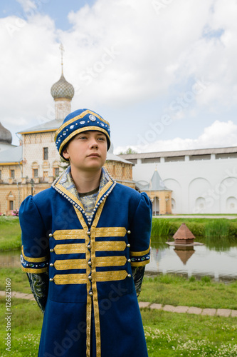 Child in national russian suit on the Kremlin Rostov Great