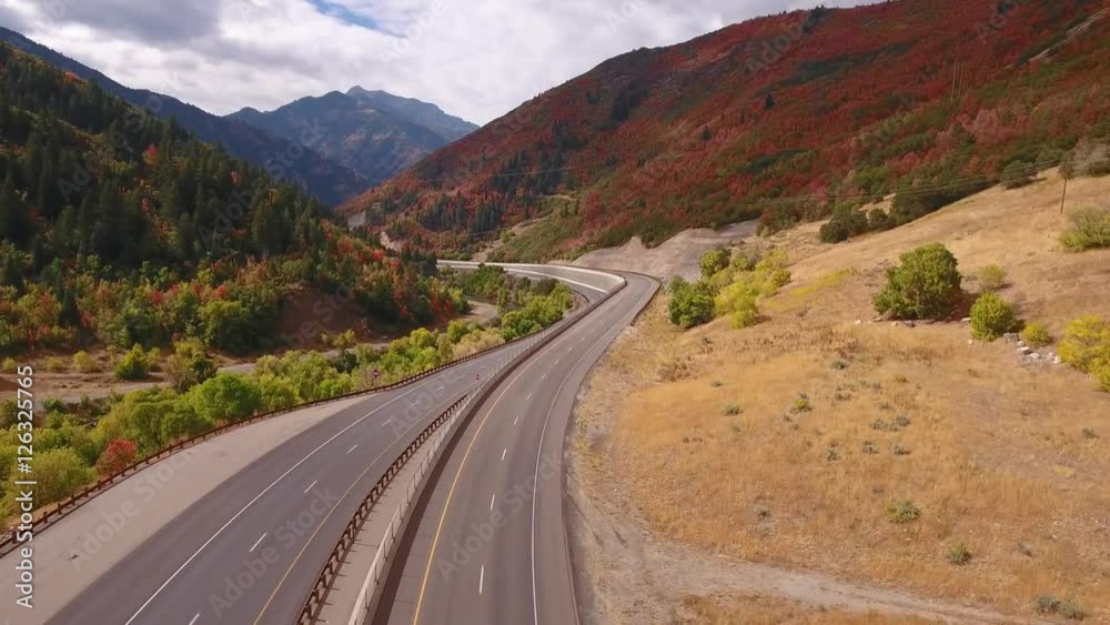 Aerial shot of cars on a mountain highway with fall leafs Aerial shot of cars on a mountain highway with fall leafs