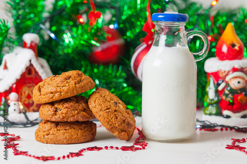 Cookies and milk on christmas background.