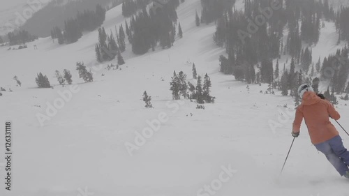 woman ski down wide open slope in perfect winter conditions