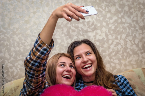 Two girls make a photo selfie