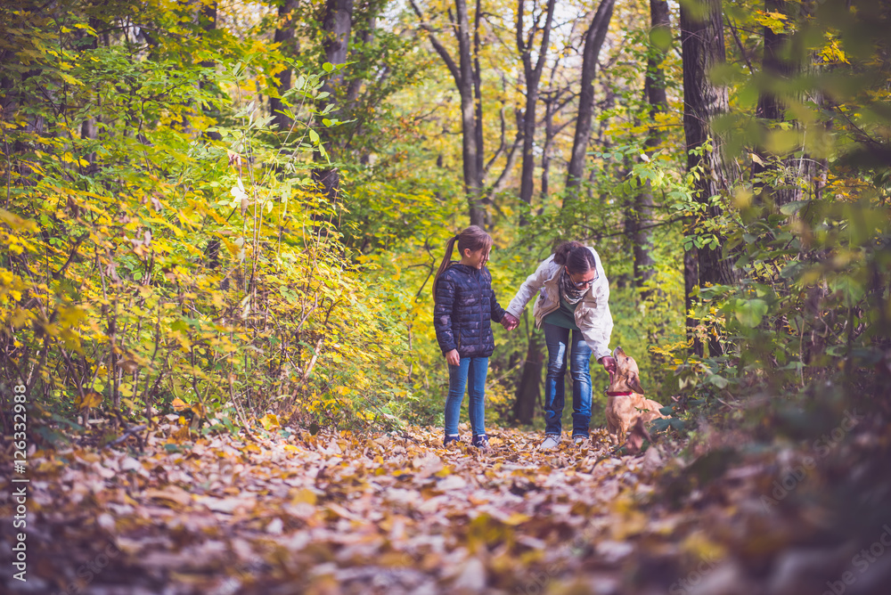 Mother and daughter hiking in a forest Mother and daughter hiking in a forest