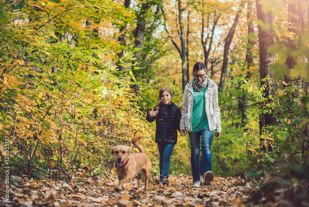 Mother and daughter hiking in a forest Mother and daughter hiking in a forest