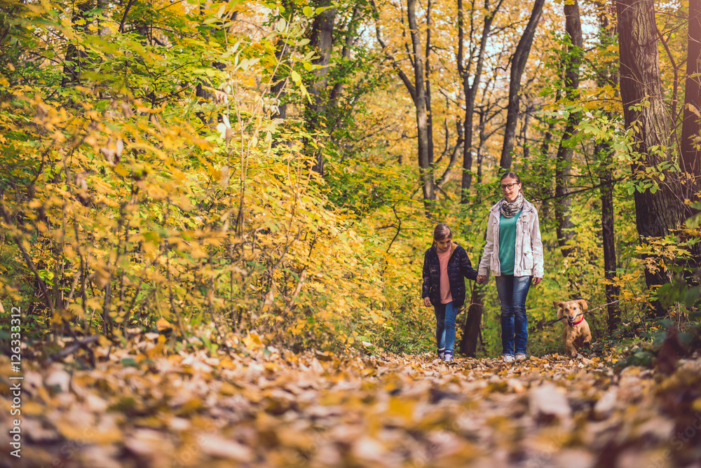 Mother and daughter hiking in a forest Mother and daughter hiking in a forest