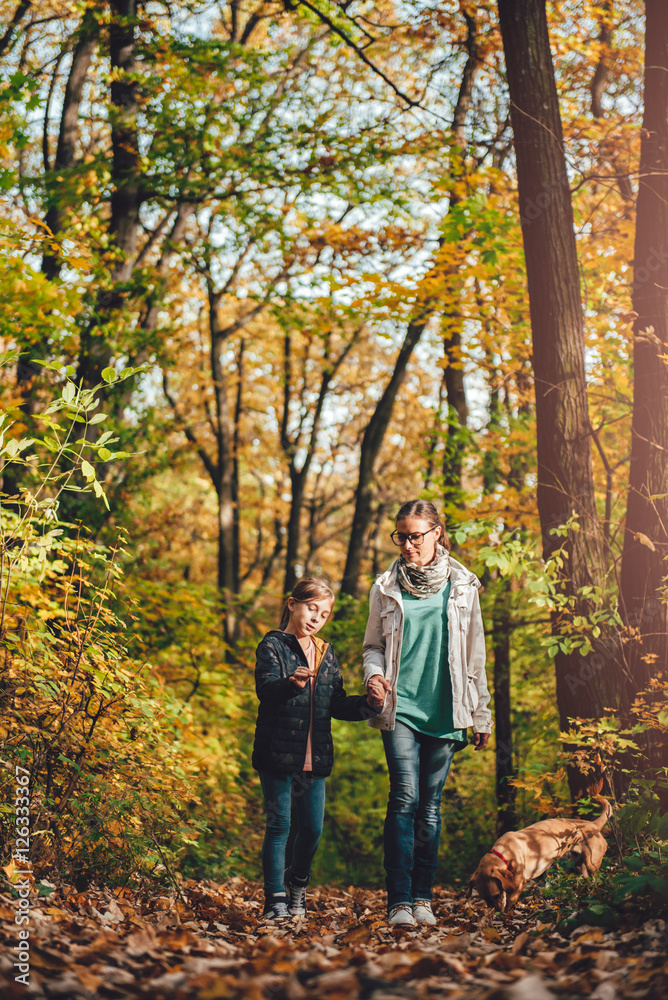 Mother and daughter hiking in a forest Mother and daughter hiking in a forest