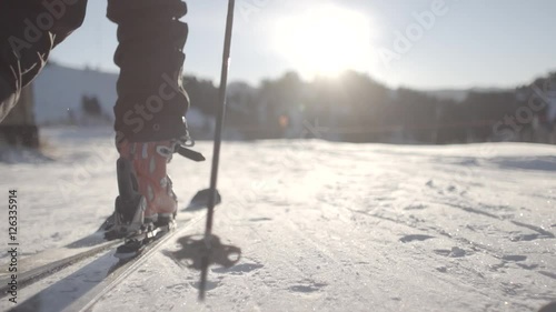 Backcountry skier hiking or ski touring at sunrise in Winter Snow on Mountain (slow motion)