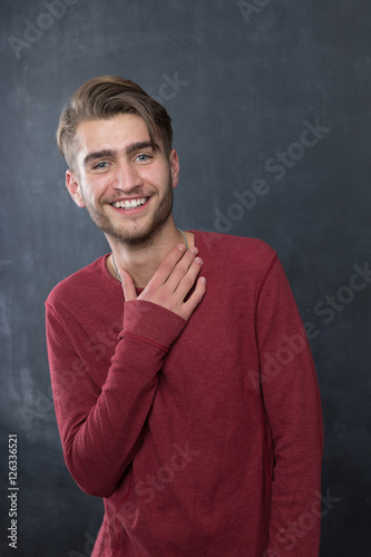 sexy fashion man or student dressed casual smiling against chalk © Myvisuals