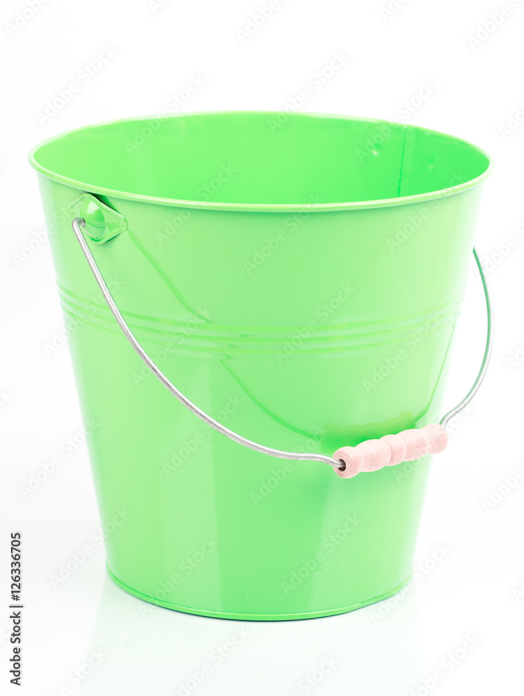 Green iron/metal bucket/pail/container with handle isolated on white background. Colorful kid child toys. Garden equipment. Green iron/metal bucket/pail/container with handle isolated on white background. Colorful kid child toys. Garden equipment.