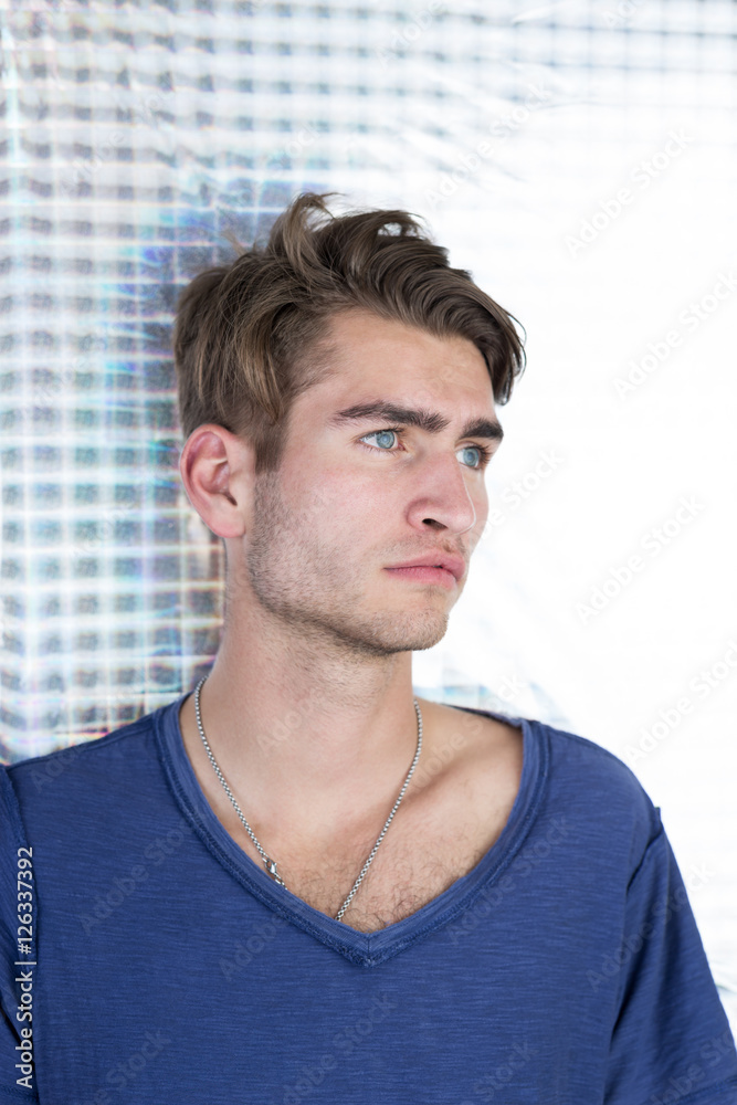 Fototapeta premium Portrait of an handsome young man with interesting background a